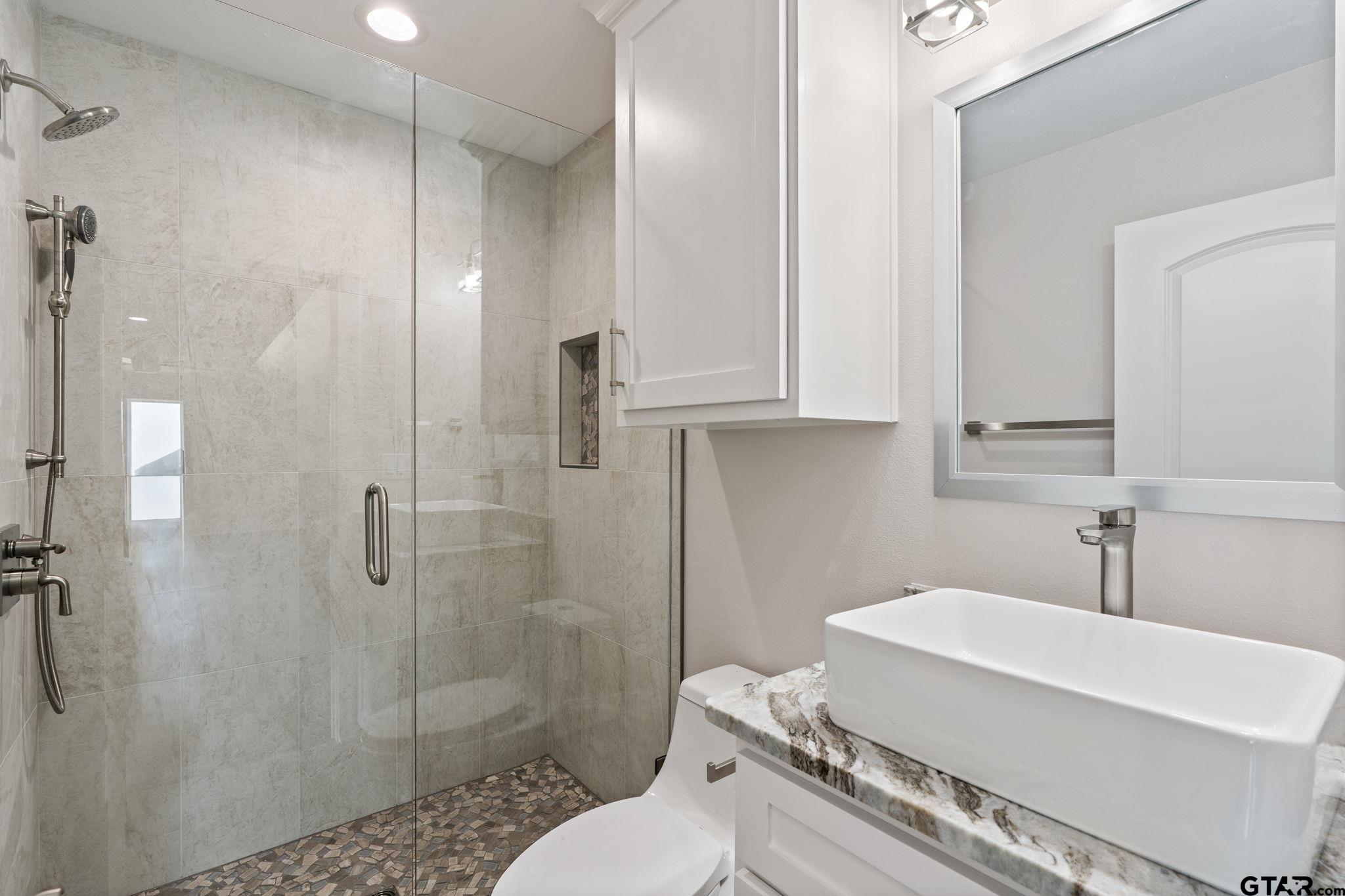 21064 Woodring Road Bullard, TX 75757 - Photo 48 of 48 a bathroom with a sink a toilet and shower