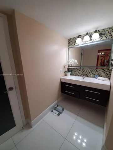 a bathroom with a sink vanity and mirror