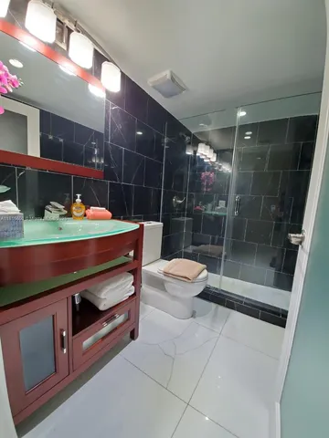 a room with table chair and glass door