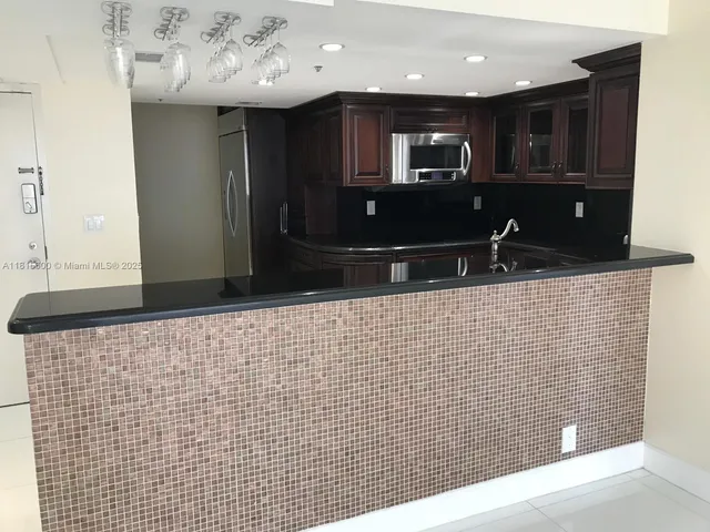 a bathroom with a sink a large mirror and a shower