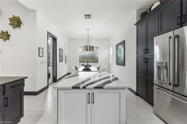 a kitchen with stainless steel appliances granite countertop a refrigerator and a stove