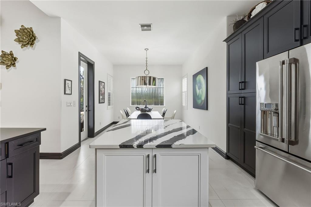 19979 Markward Crossing Estero, FL 33928 - Photo 14 of 36 a kitchen with stainless steel appliances granite countertop a refrigerator and a stove