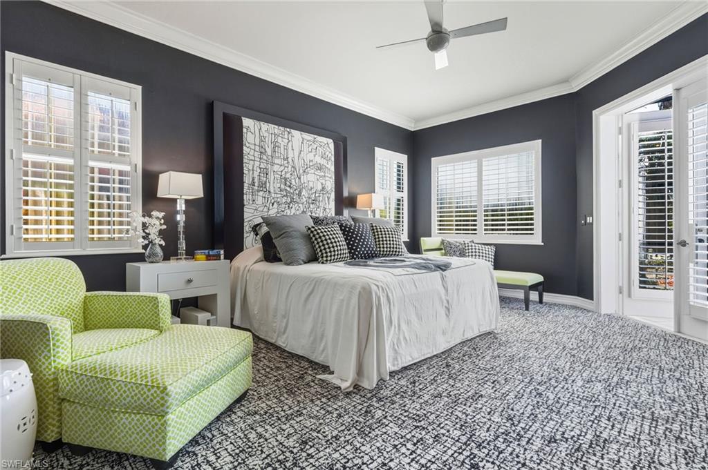 19979 Markward Crossing Estero, FL 33928 - Photo 16 of 36 a spacious bedroom with a bed a couch and a window