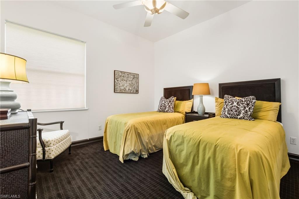 19979 Markward Crossing Estero, FL 33928 - Photo 22 of 36 a spacious bedroom with two beds and a chandelier