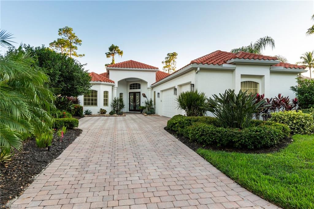 19979 Markward Crossing Estero, FL 33928 - Photo 5 of 36 a front view of a house with a yard and potted plants