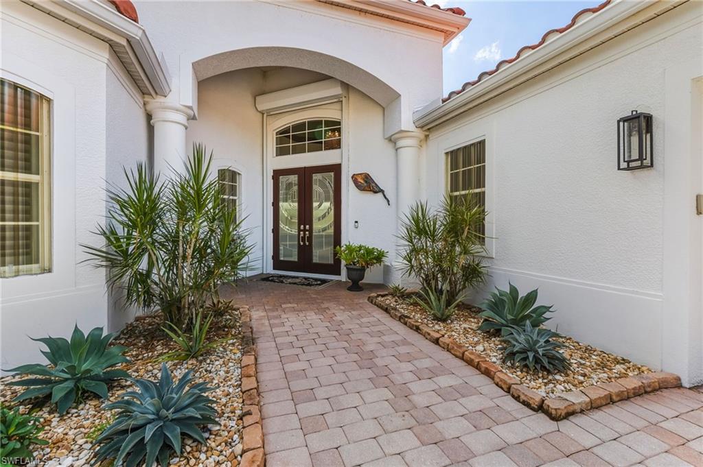 19979 Markward Crossing Estero, FL 33928 - Photo 6 of 36 a house with palm tree in front