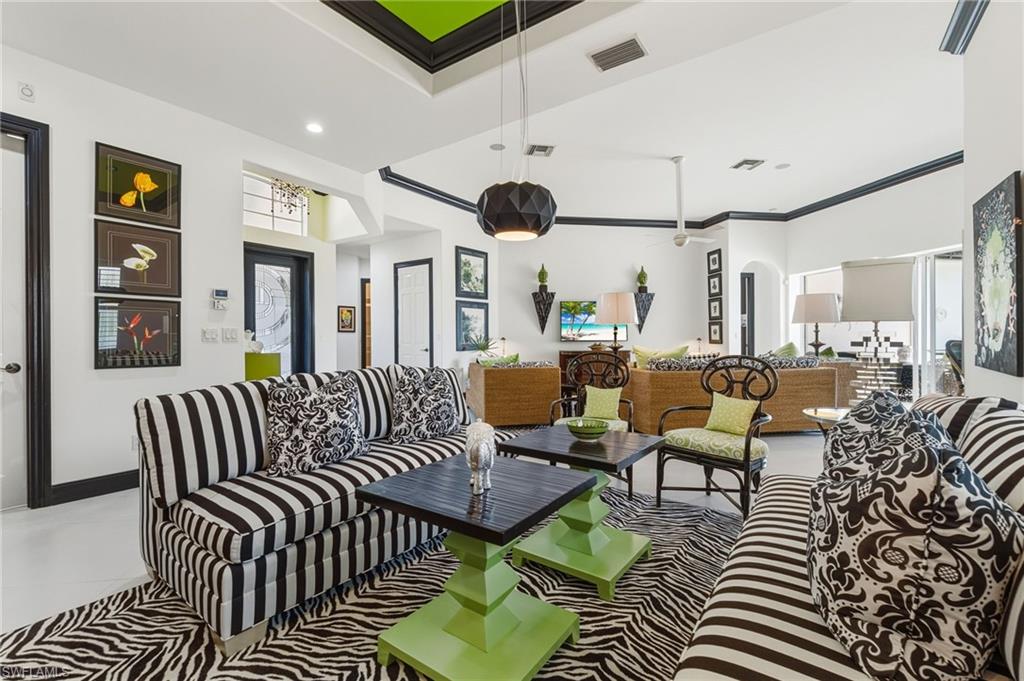 19979 Markward Crossing Estero, FL 33928 - Photo 10 of 36 a living room with furniture kitchen view and a chandelier