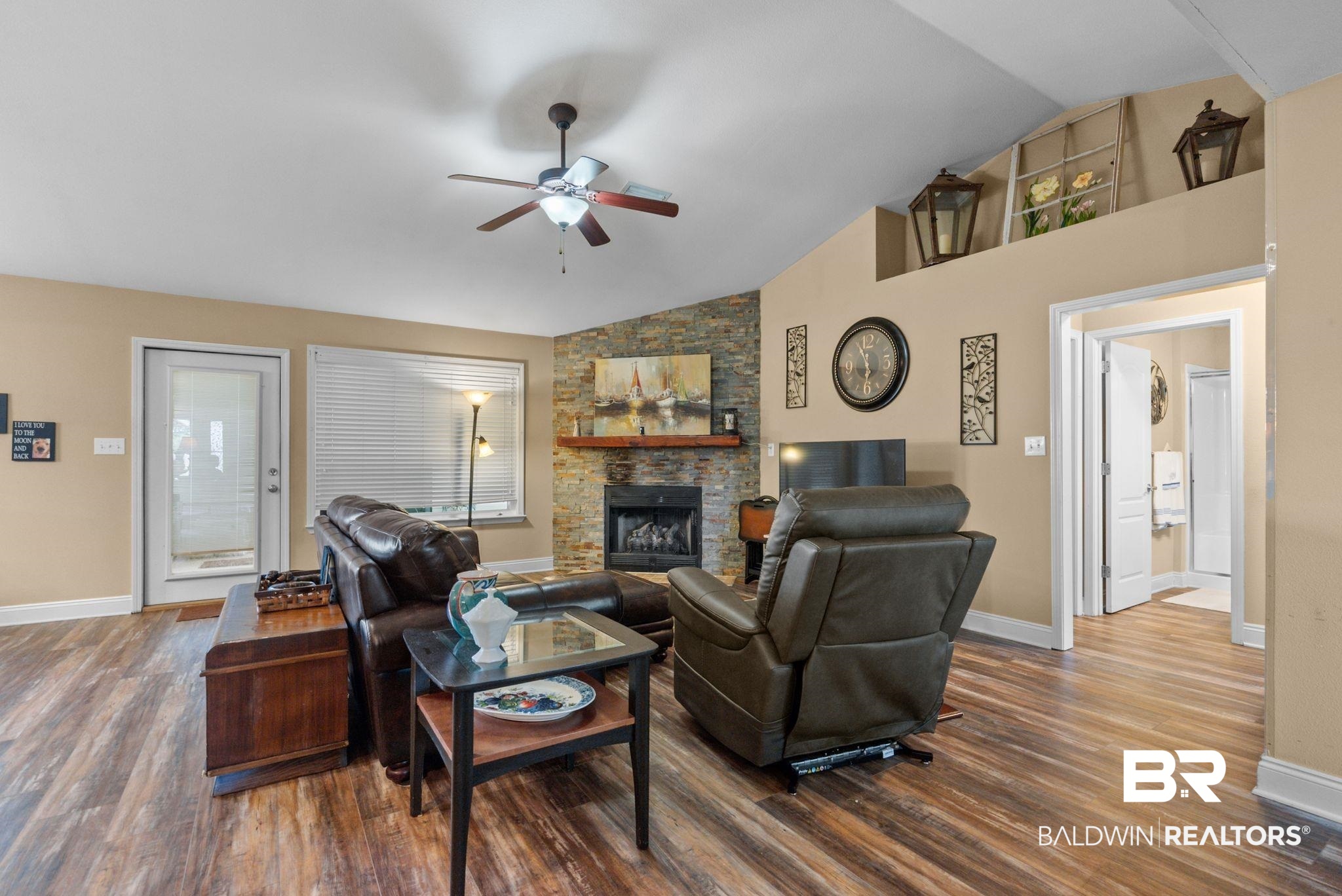 562 Vestige Mews Foley, AL 36535 - Photo 10 of 54 Living area featuring wood-finish flooring, a vaulted ceiling, and a ceiling fan with integrated lighting