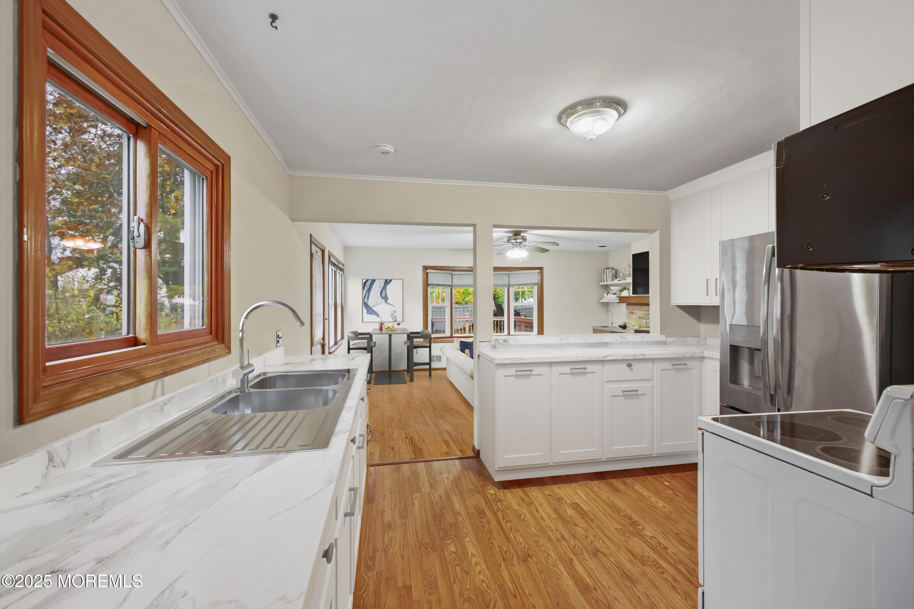 26 Edgewater Drive Matawan, NJ 07747 - Photo 11 of 23 a large kitchen with a large window a sink and stainless steel appliances