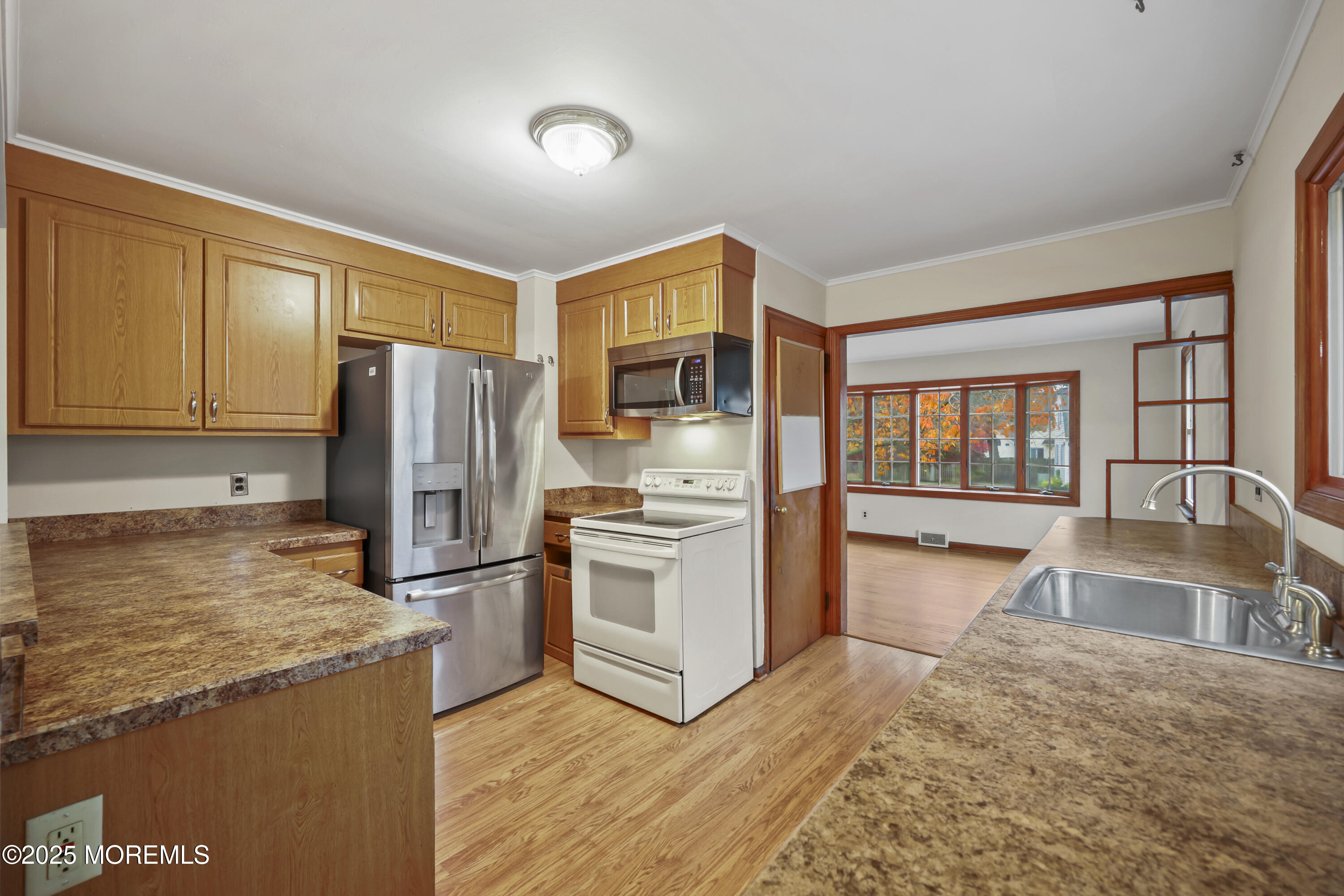 26 Edgewater Drive Matawan, NJ 07747 - Photo 12 of 23 a kitchen with granite countertop a refrigerator and a stove top oven