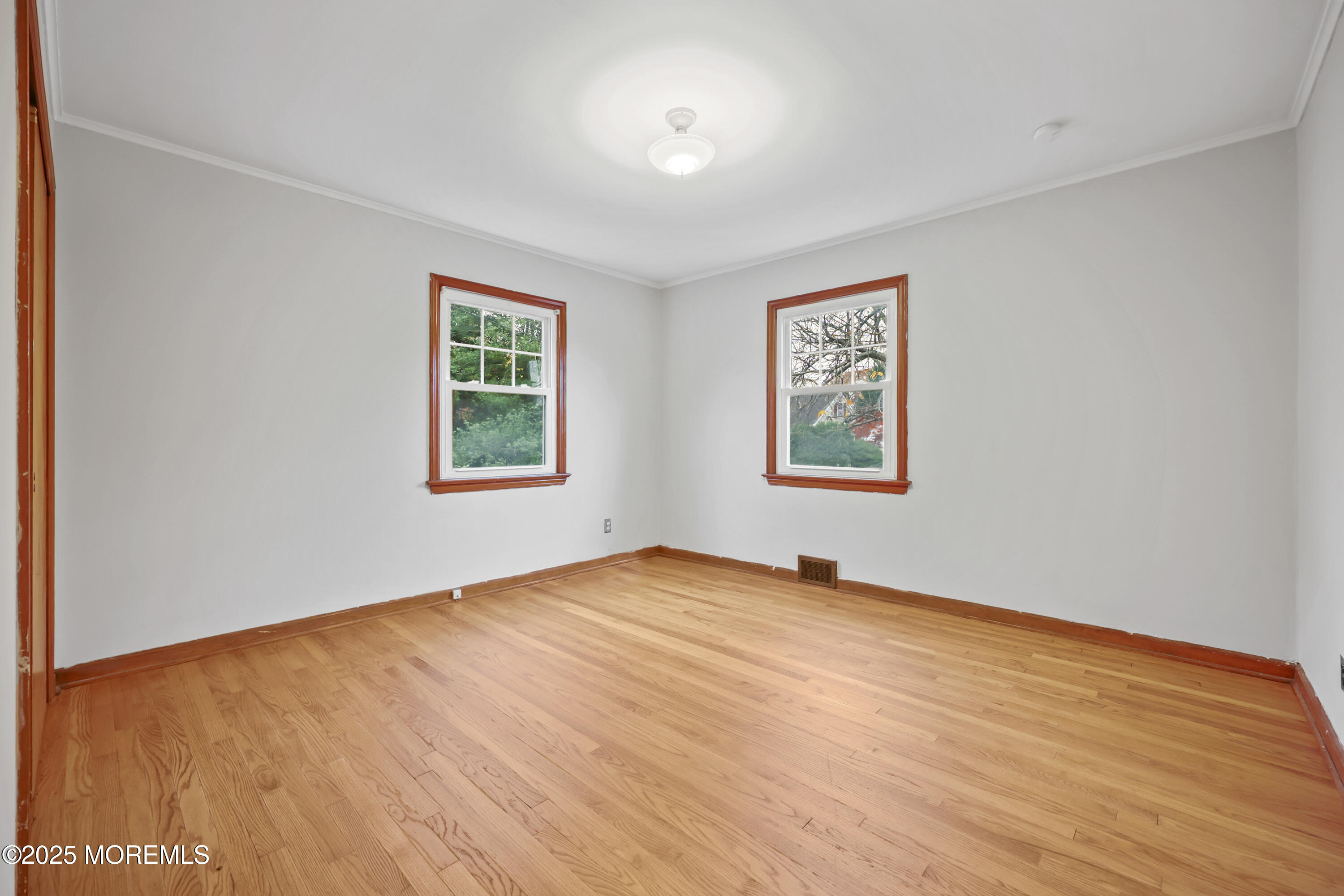 26 Edgewater Drive Matawan, NJ 07747 - Photo 15 of 23 an empty room with wooden floor and windows