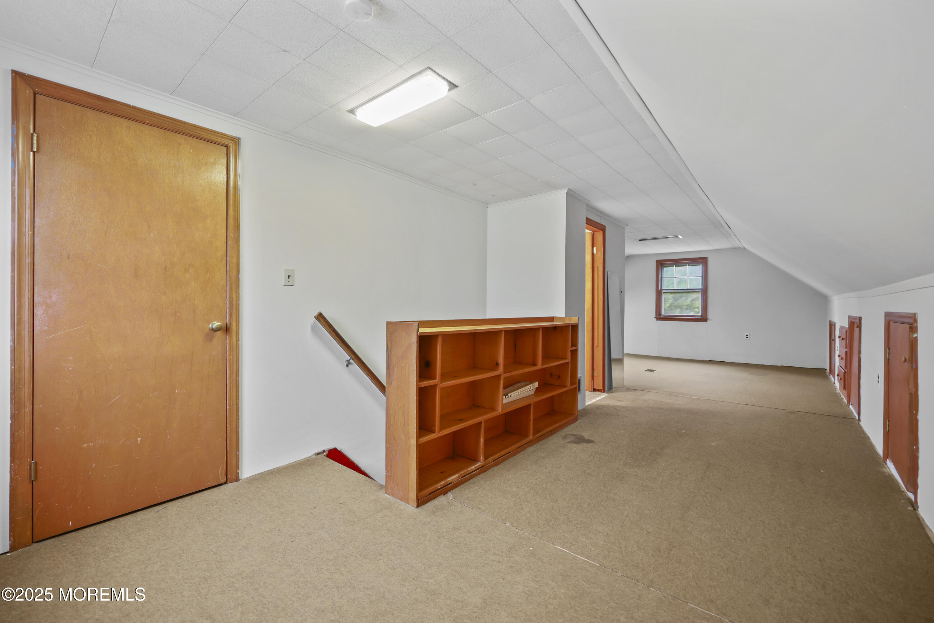 26 Edgewater Drive Matawan, NJ 07747 - Photo 21 of 23 a view of an empty room with window and stairs