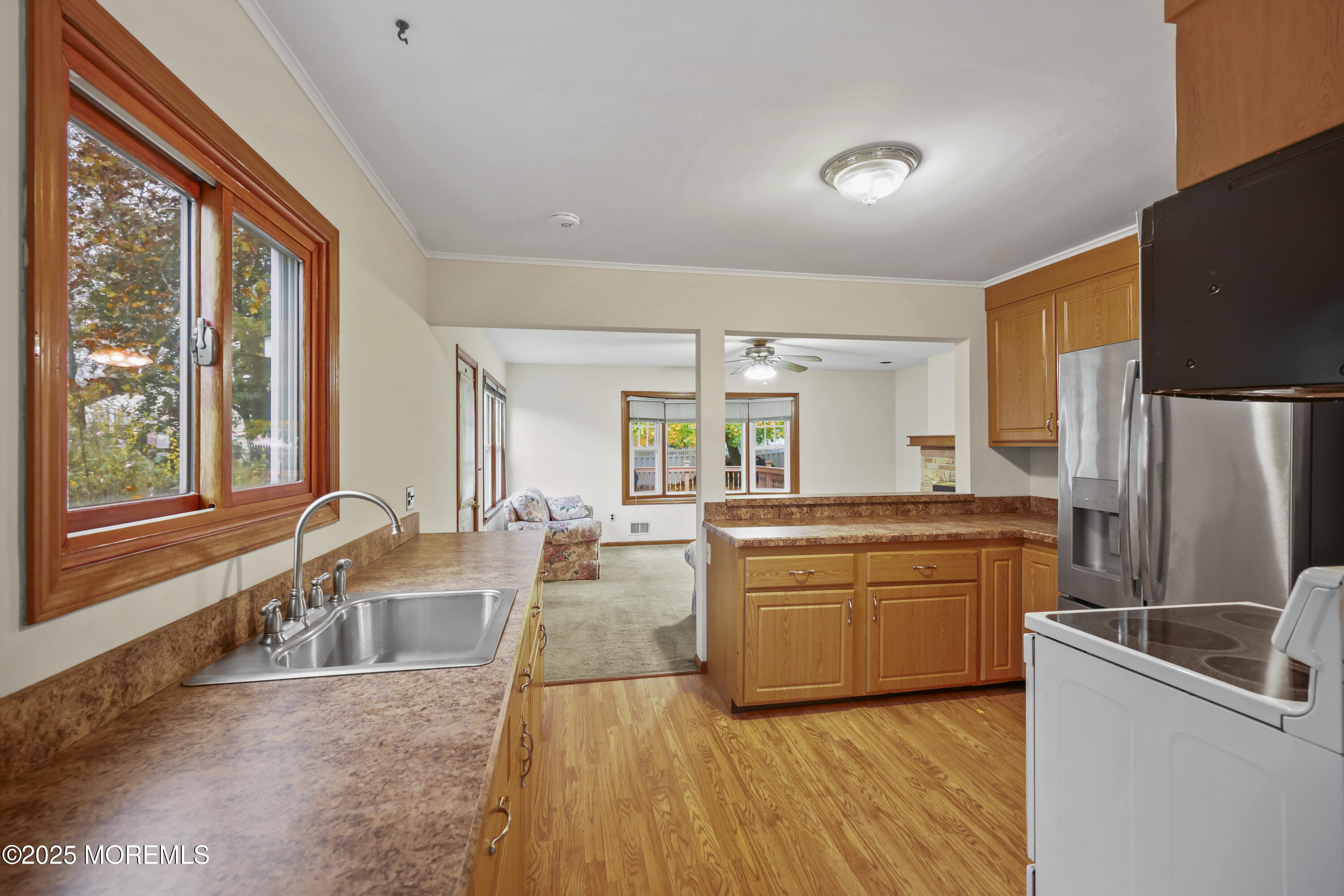 26 Edgewater Drive Matawan, NJ 07747 - Photo 10 of 23 a large kitchen with granite countertop a large window and stainless steel appliances