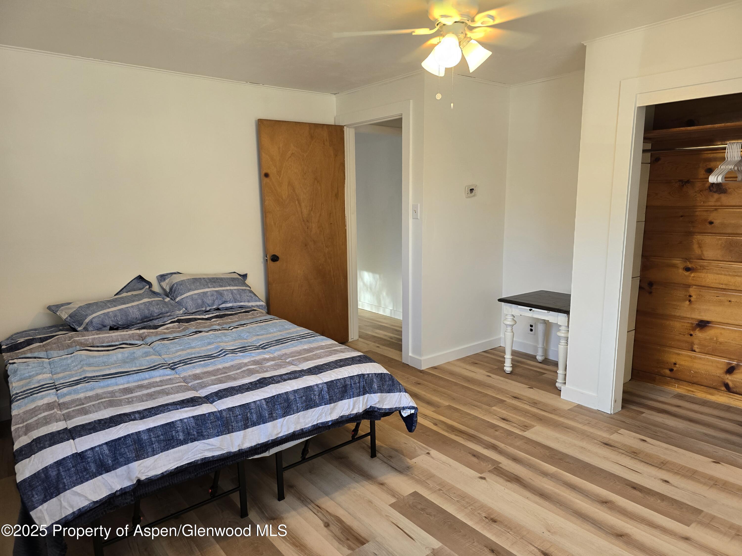 770 School Street Craig, CO 81625 - Photo 11 of 19 a bedroom with a bed and a chandelier