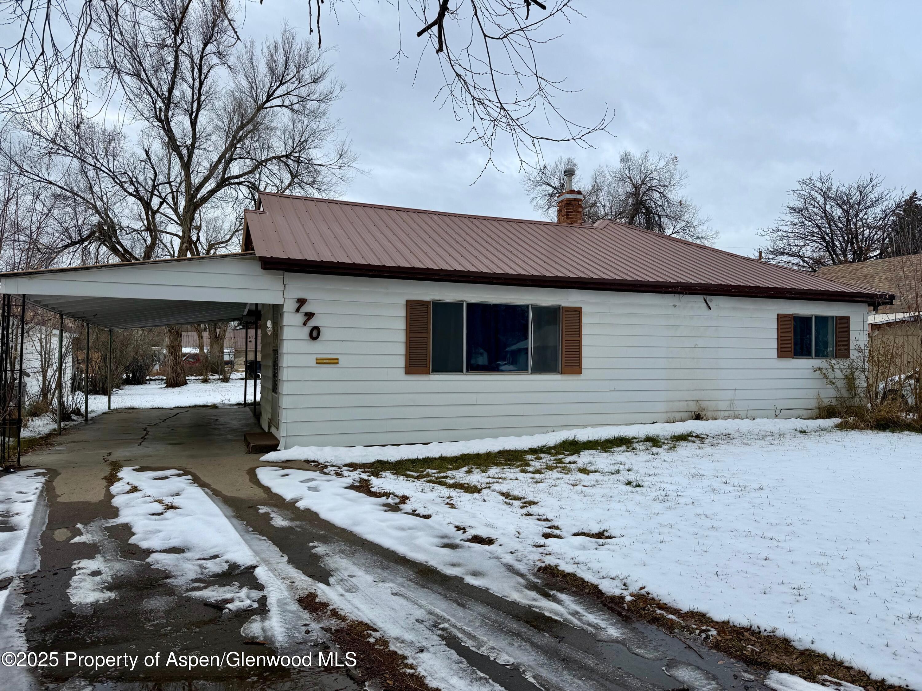 770 School Street Craig, CO 81625 - Photo 3 of 19 a front view of a house with a yard