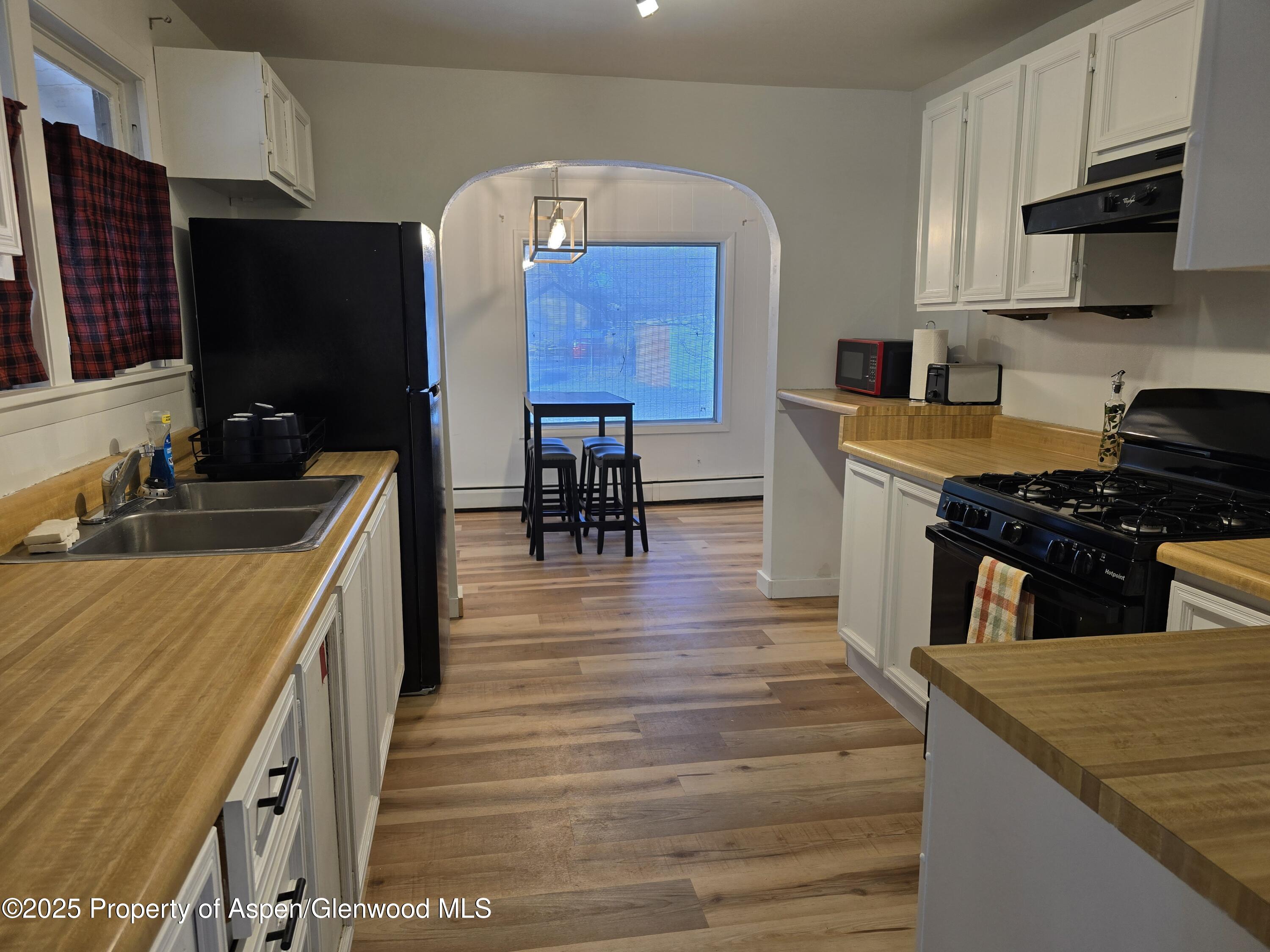 770 School Street Craig, CO 81625 - Photo 7 of 19 a kitchen with stainless steel appliances granite countertop a sink stove and refrigerator