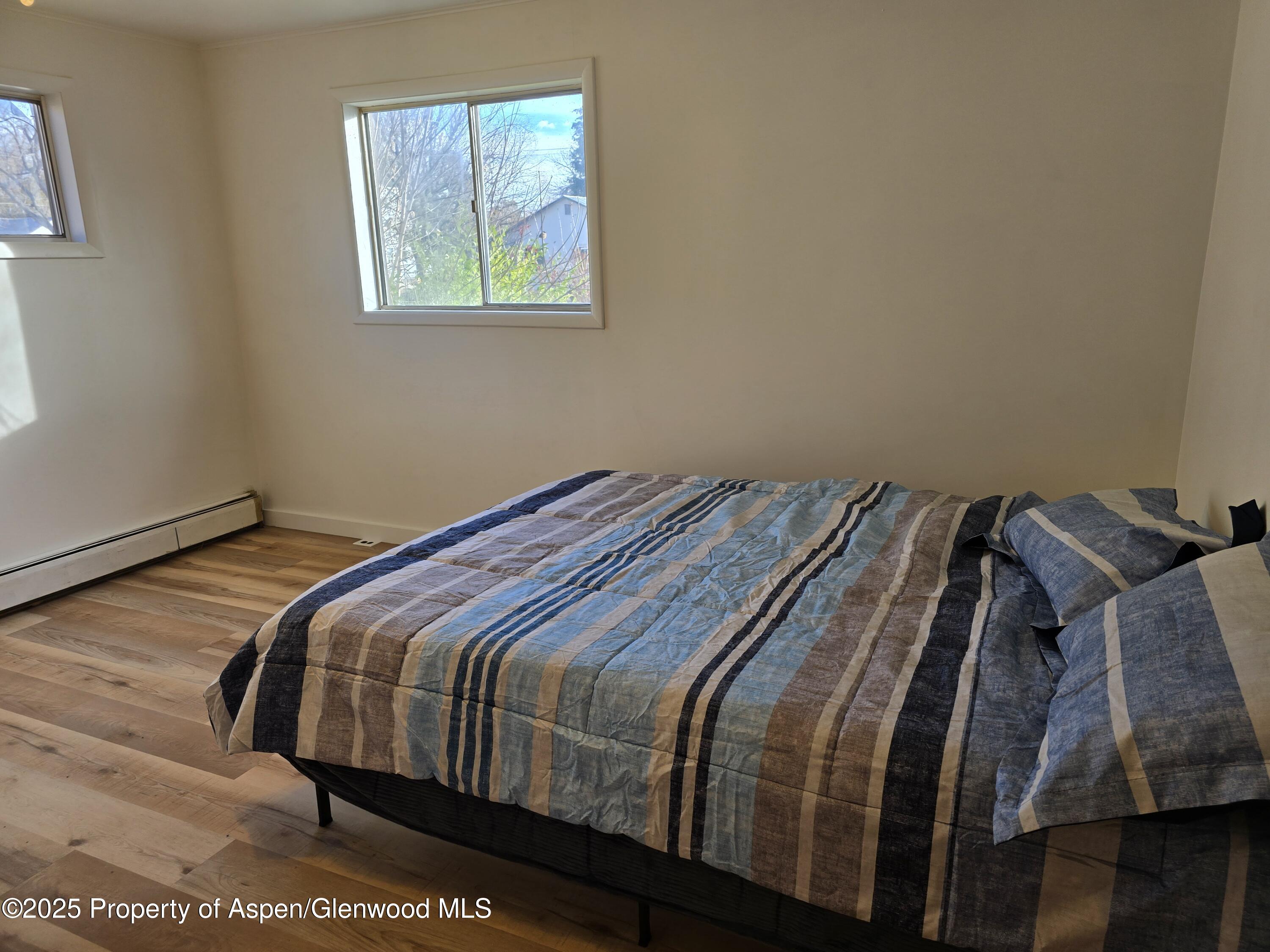 770 School Street Craig, CO 81625 - Photo 10 of 19 a bedroom with a bed and wooden floor