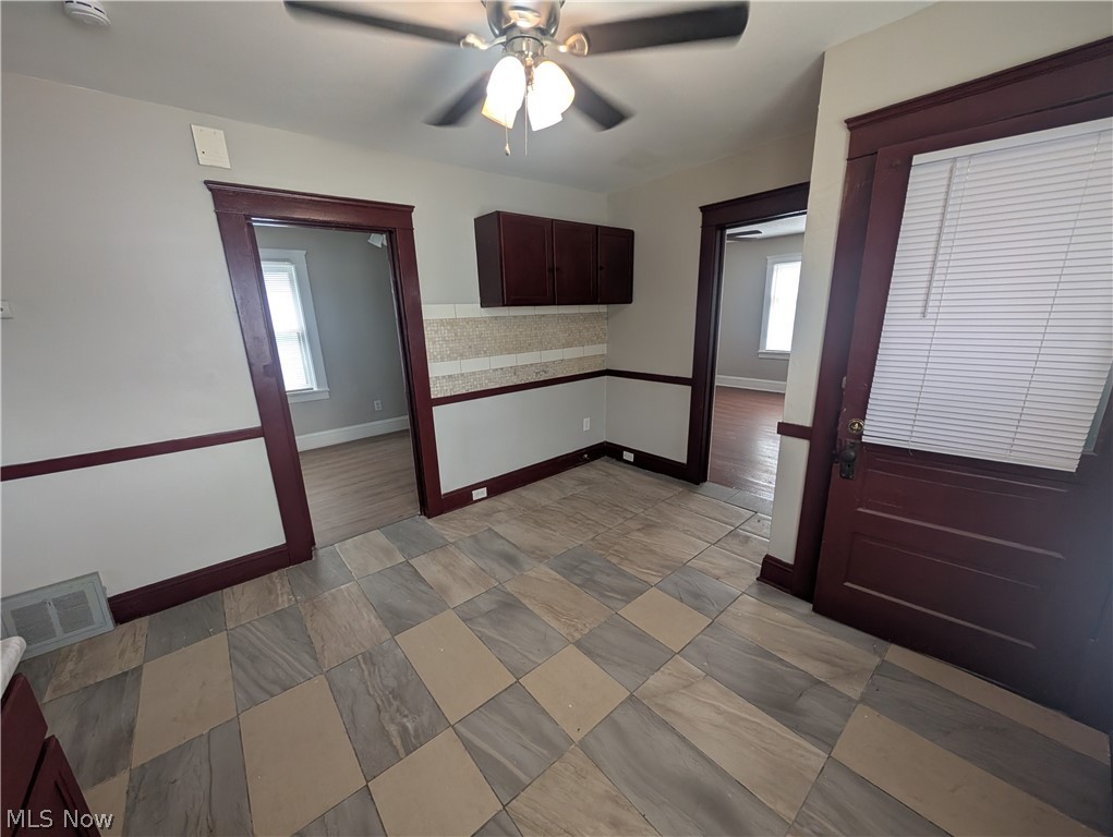 7515 Ottawa Road Cleveland, OH 44105 - Photo 8 of 21 Room featuring diagonally laid tile flooring, a ceiling fan with integrated lighting, and dark wood trim