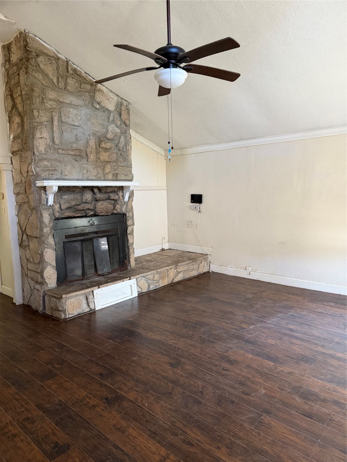 323 Reppert Street Bacliff, TX 77518 - Photo 2 of 8 a view of empty room with wooden floor fireplace and a window