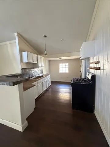 a kitchen with granite countertop a refrigerator and a stove