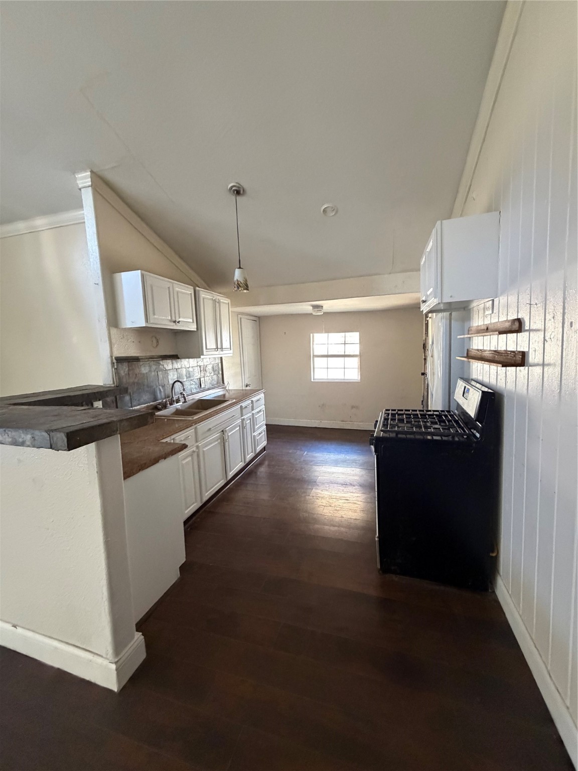 323 Reppert Street Bacliff, TX 77518 - Photo 3 of 8 a kitchen with granite countertop a refrigerator and a stove