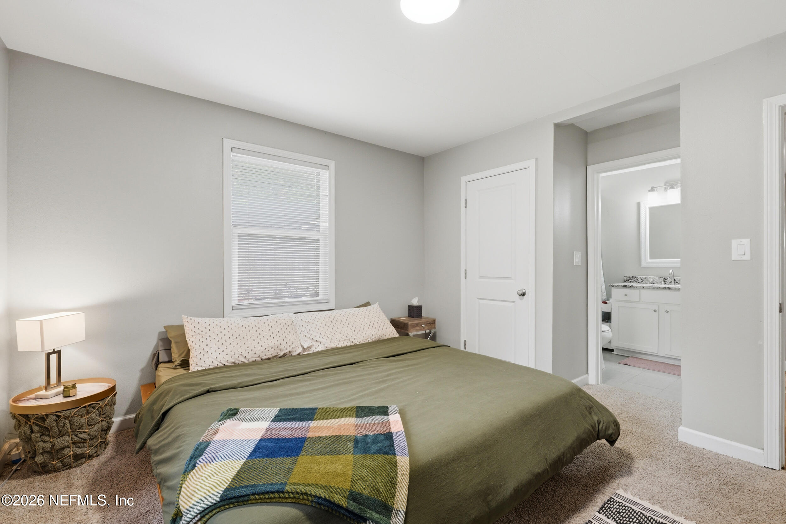 2032 Inwood Terrace Jacksonville, FL 32207 - Photo 14 of 27 a bedroom with a bed and a lamp