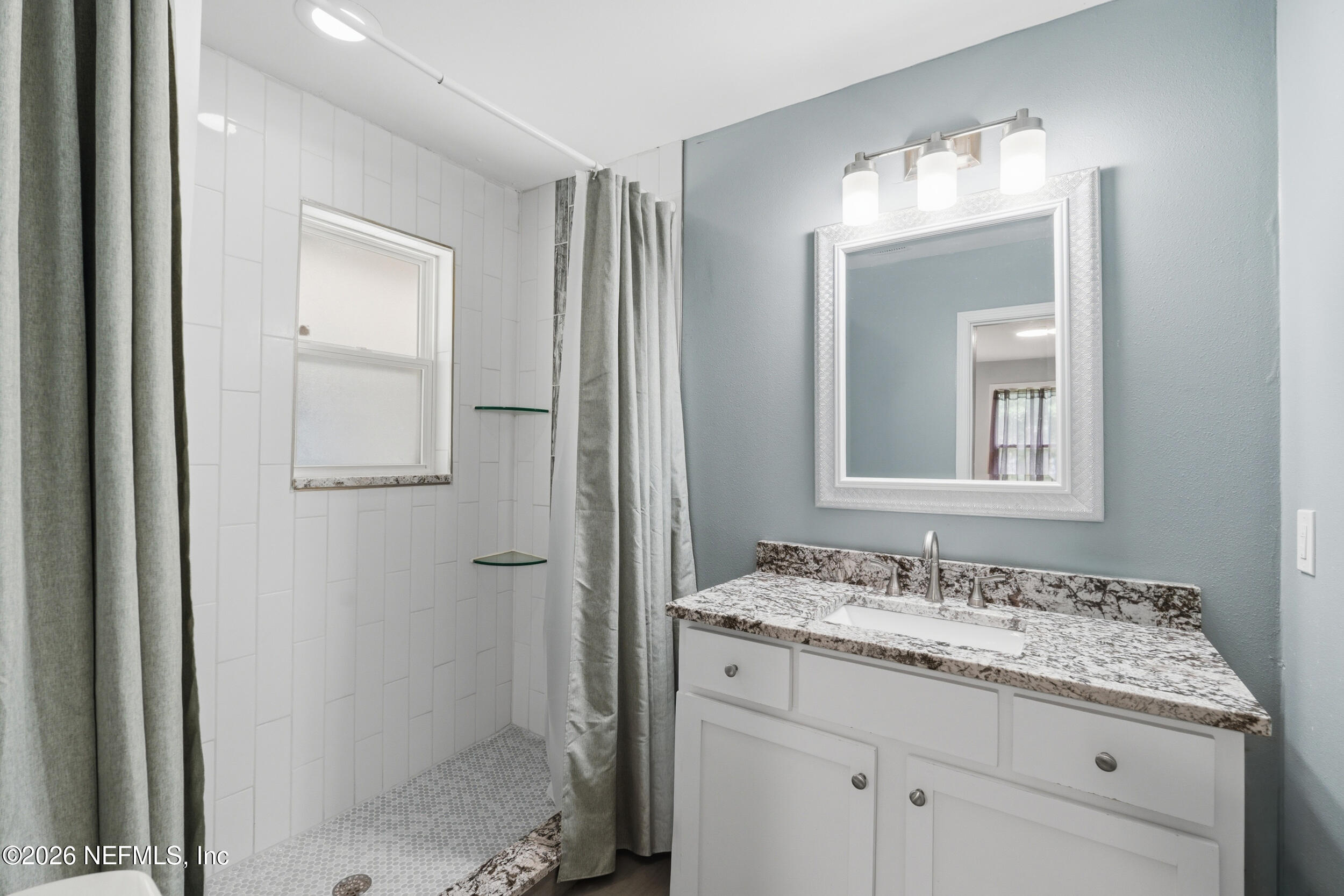 2032 Inwood Terrace Jacksonville, FL 32207 - Photo 15 of 27 a bathroom with a granite countertop sink and a mirror