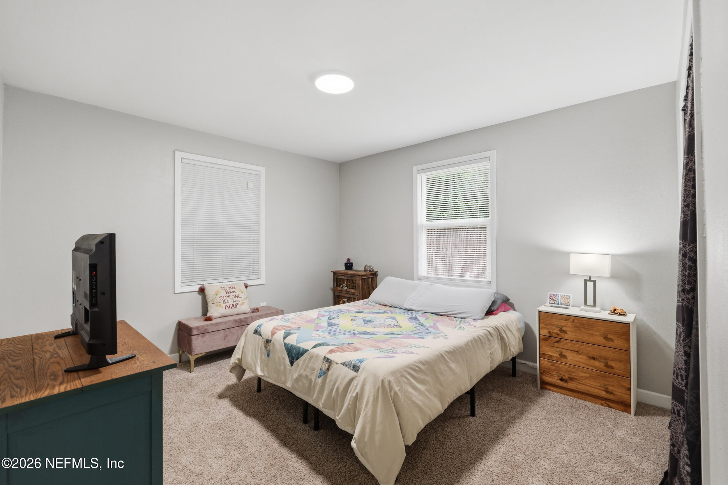 2032 Inwood Terrace Jacksonville, FL 32207 - Photo 16 of 27 a bedroom with a bed desk and a window