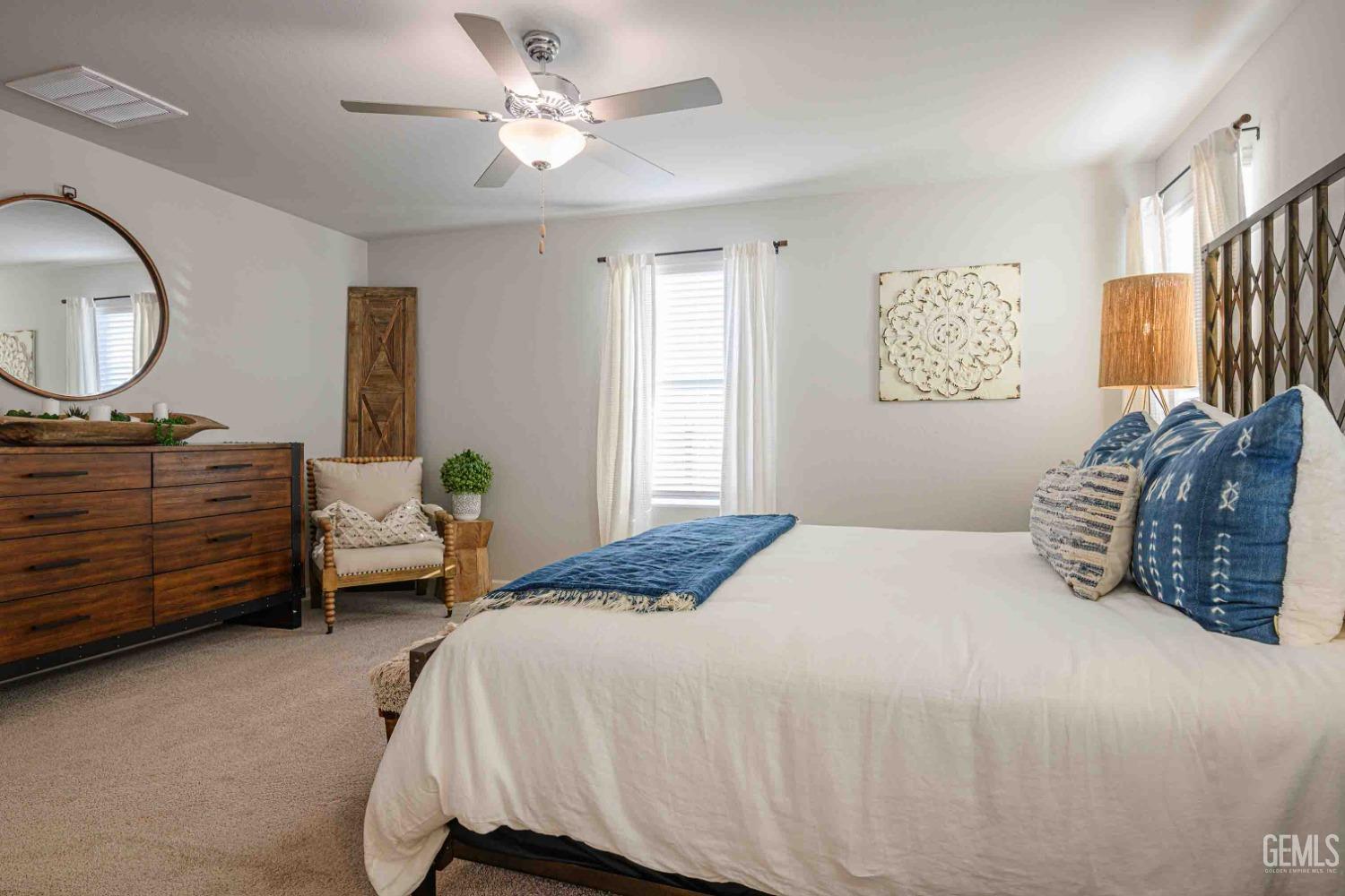 Undisclosed Address Bakersfield, CA 93313 - Photo 11 of 21 a bedroom with a bed dresser and a window