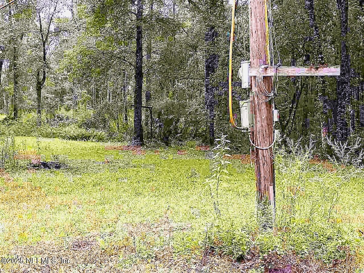 799 Roberts Aman Road Perry, FL 32347 - Photo 9 of 13 a backyard of a house with lots of green space