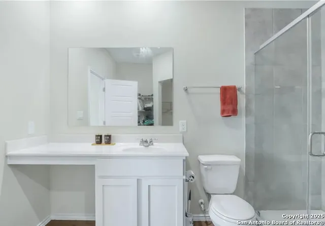 a bathroom with a sink toilet and mirror
