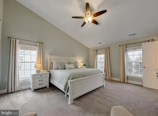 a bedroom with a bed and a ceiling fan