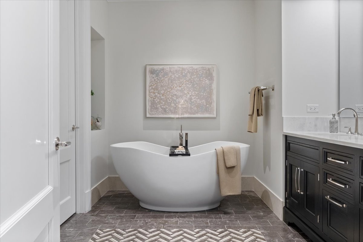 9 West Walton Street, Unit 702 Chicago, IL 60610 - Photo 23 of 38 a white bath tub sitting in a bathroom