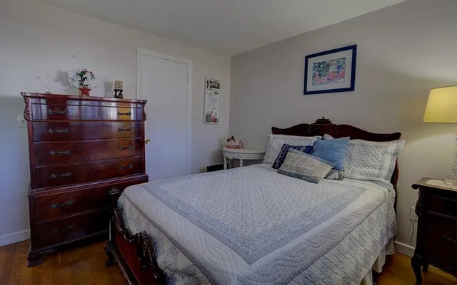 a bedroom with a bed and a dresser