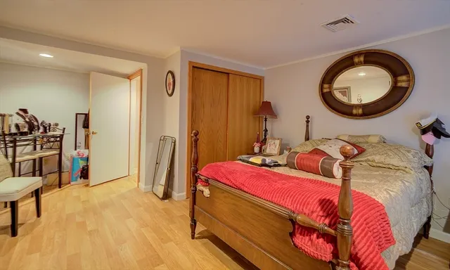 a bedroom with bed and a mirror
