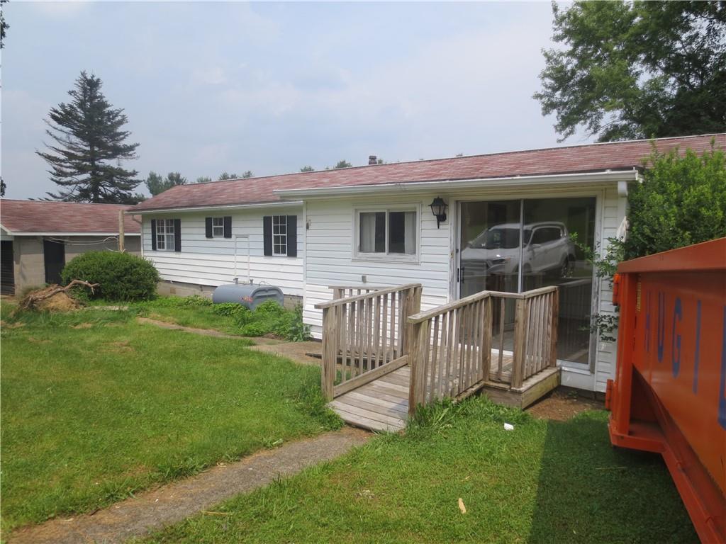 a view of a house with a yard and deck