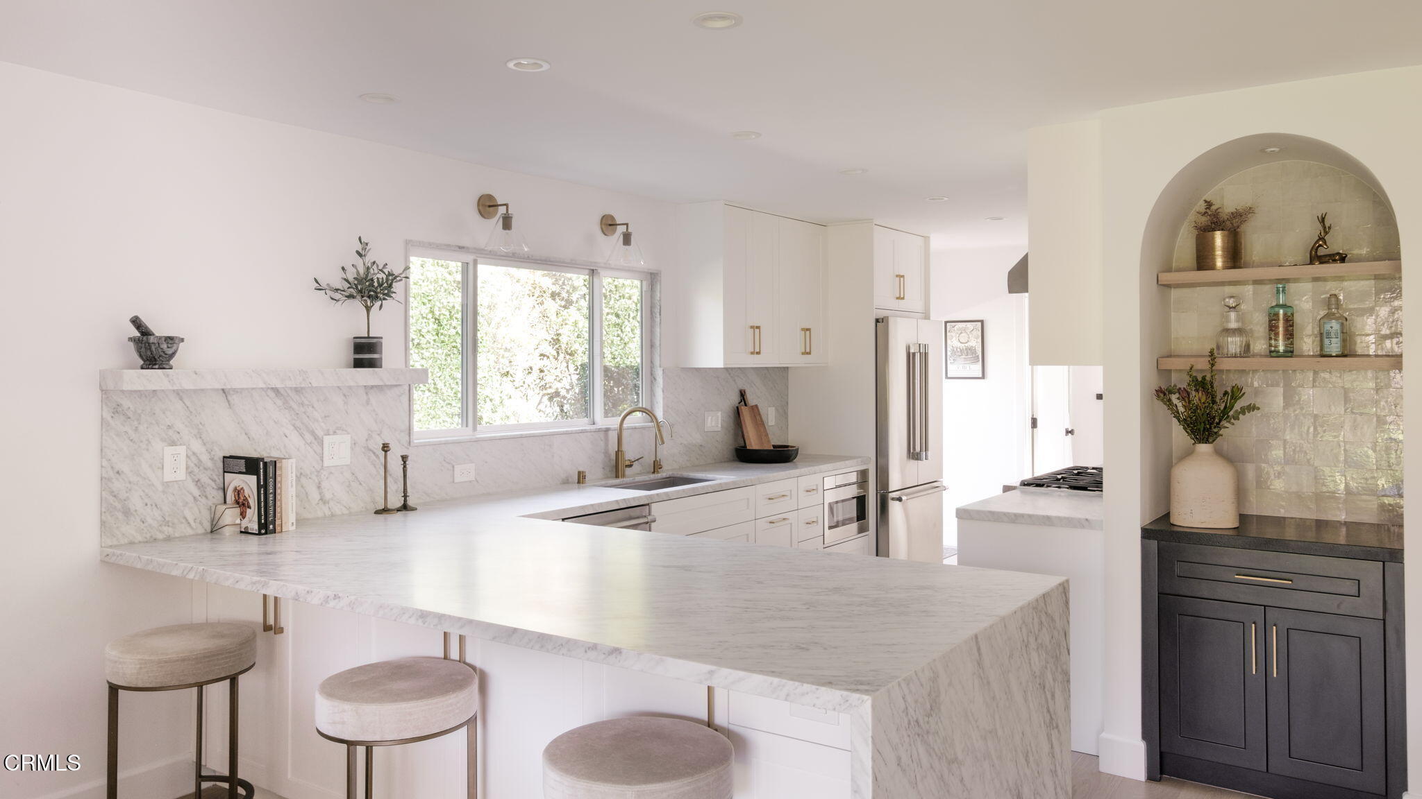 a kitchen with granite countertop a sink stainless steel appliances and cabinets