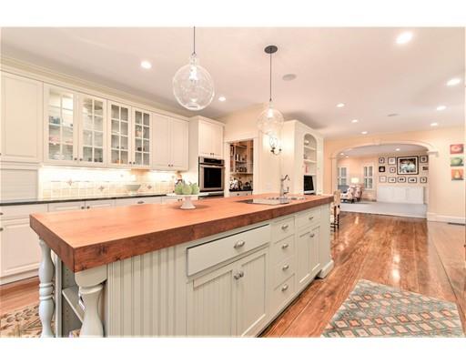 24 Stonefield Court Needham, MA 02492 - Photo 16 of 42 a large kitchen with kitchen island a large counter space a sink appliances and a counter top space