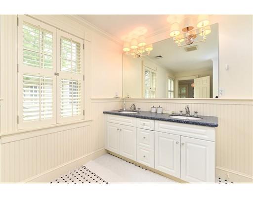 24 Stonefield Court Needham, MA 02492 - Photo 29 of 42 a bathroom with a granite countertop sink a large mirror and a window