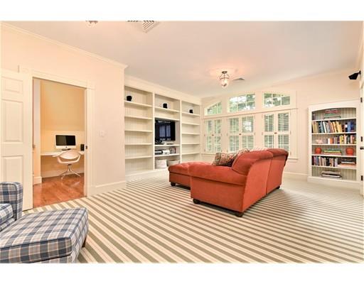 24 Stonefield Court Needham, MA 02492 - Photo 31 of 42 a living room with furniture a flat screen tv and kitchen view