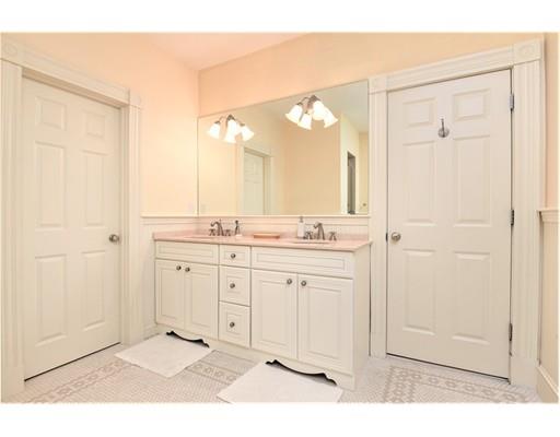 24 Stonefield Court Needham, MA 02492 - Photo 32 of 42 a bathroom with a sink a mirror and a shower
