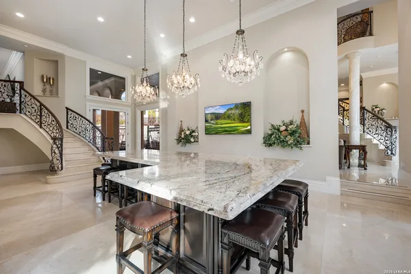a view of a dining room with furniture and a chandelier