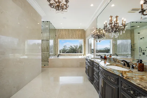 a large bathroom with a tub sink and mirror