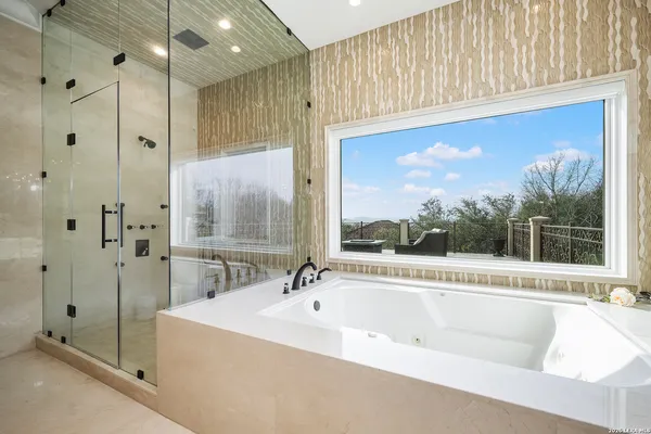 a bathroom with a bathtub and a shower