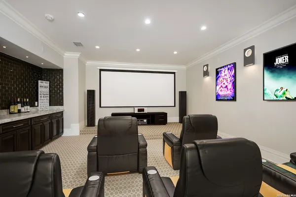 a room with furniture projector and screen