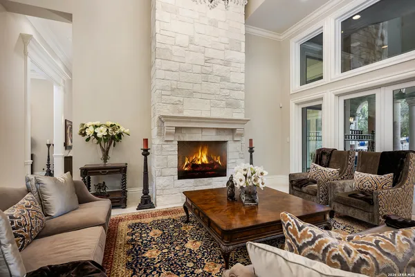 a living room with furniture fireplace and window