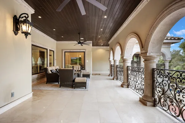 a kitchen with stainless steel appliances granite countertop a stove and a view of living room