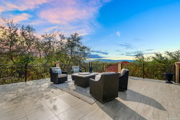 a view of a terrace with couches and sky view