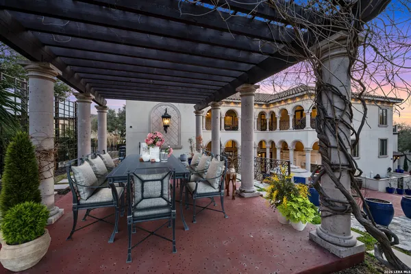 a view of a patio with table and chairs and potted plants