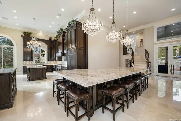 a large kitchen with a table and chairs